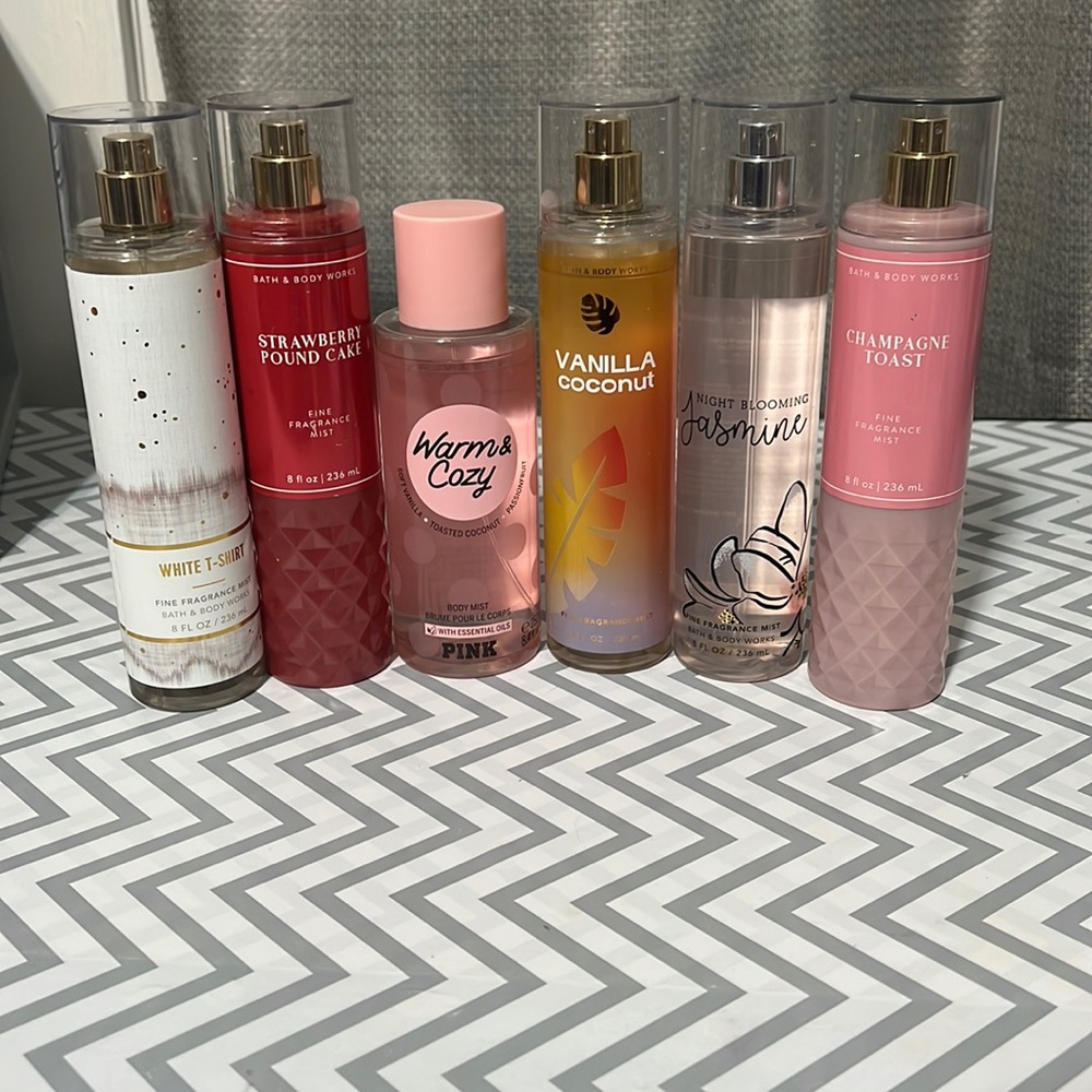 Multiple bottles of Bath and Body Works perfume and one PINK perfume.